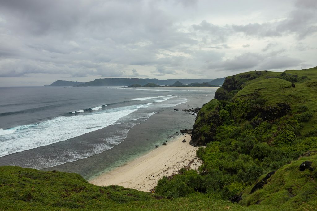 a beach with a body of water by it