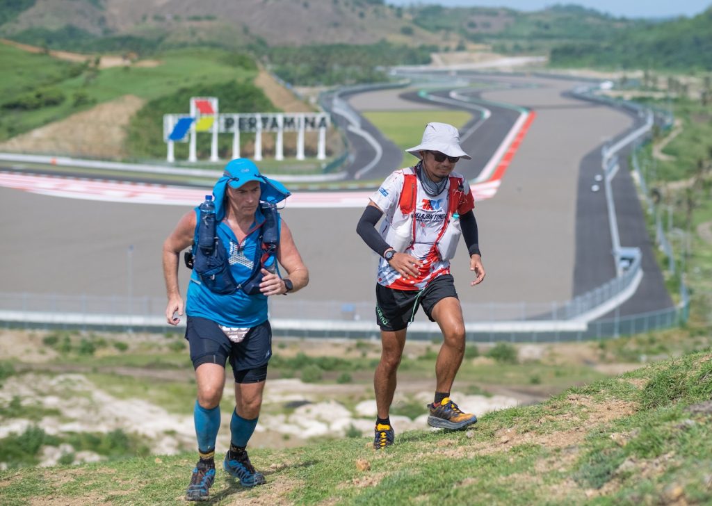 a couple of people that are running down a hill